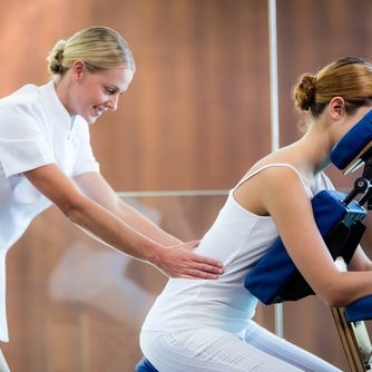 Woman Receiving Massage In Massage Chair